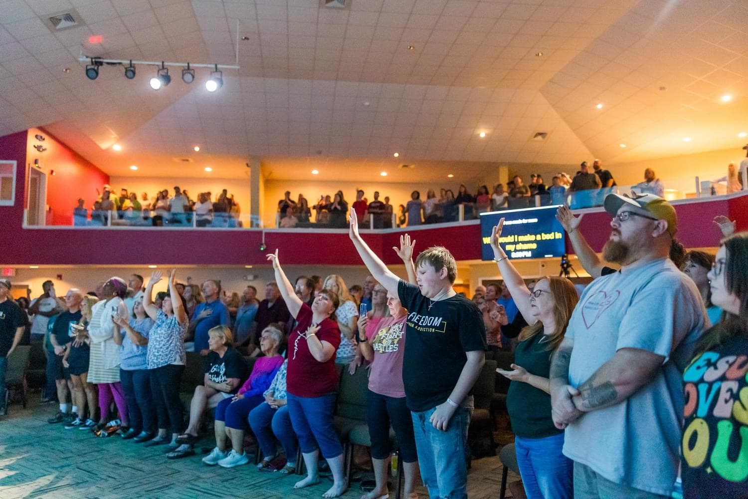Crowd with hands raised in worship at a Shenandoah Valley Teen Challenge community event